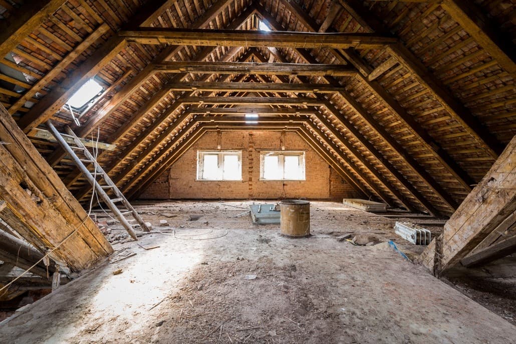Unconverted loft with original roof timbers before conversion work begins